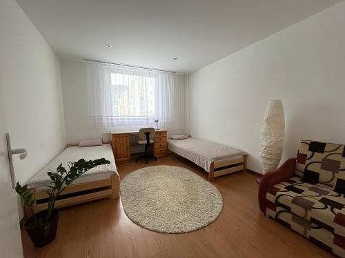 a living room with a bed and a couch at Apartmán Majka in Snina