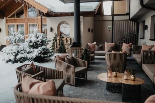 a lobby with couches and tables and a christmas tree at Hotel Berghof - St Johann in Salzburg in Sankt Johann im Pongau