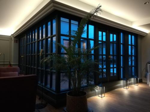 a large glass room with a potted plant in it at Hotel Avenue Louise Brussels Trademark Collection by Wyndham in Brussels