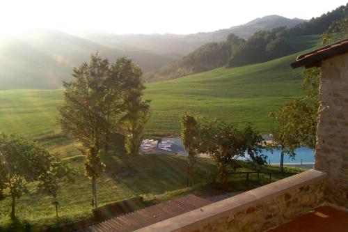 a view from the balcony of a house with green hills at Palazzo Loup Hotel in Loiano