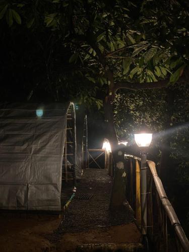 a couple of lights on a fence at night at Tent stay mankulam in Viripara
