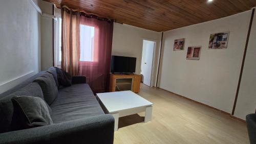 a living room with a couch and a table at Spanish style flat close to center in Alicante