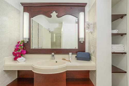 a bathroom with a sink and a mirror at Village Pierre & Vacances Sainte Luce in Sainte-Luce