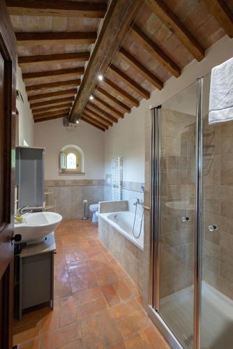 a bathroom with a tub and a sink and a shower at Villa La Pergola in Cortona