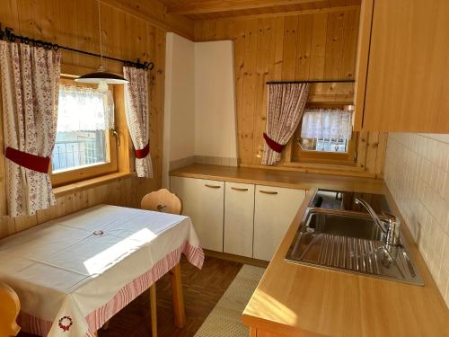 a small kitchen with a table and a sink at Scurcia in Ortisei