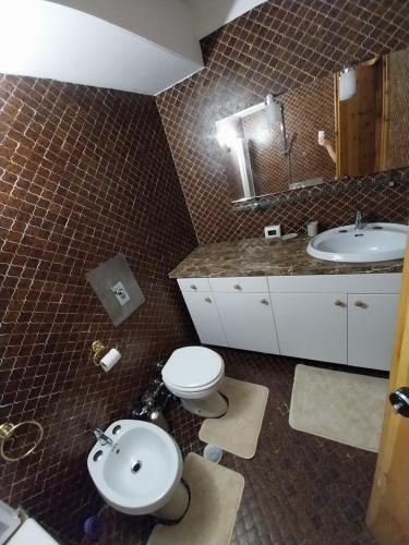 a bathroom with a toilet and a sink at Casa Cornella cir226 in Pila