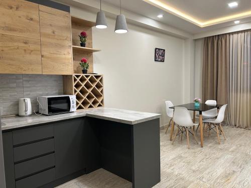 a kitchen with a counter and a table and chairs at Spacious APT next to Republic Square in Yerevan