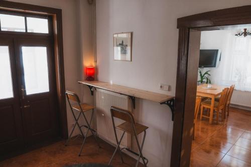 a room with a bar with chairs and a table at Vila Anobis in Nové Hamry