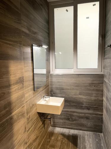 a bathroom with a sink and a mirror at The Old Mint House sleeps 15 in Valletta