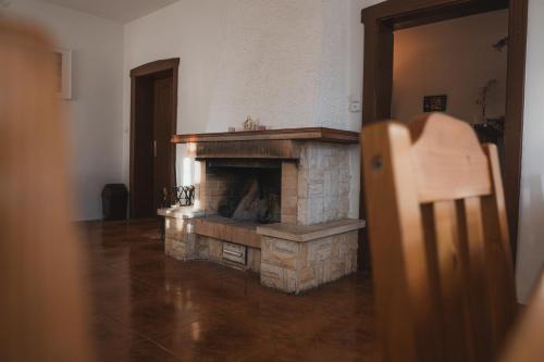 a living room with a stone fireplace in a house at Vila Anobis in Nové Hamry