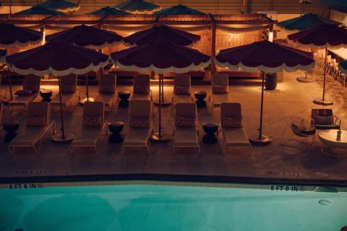 an overhead view of a pool with chairs and umbrellas at Royal Sun Palm Springs in Palm Springs