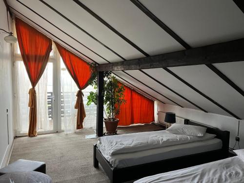 a bedroom with two beds and a large window at Pensiunea Maria Sibiu in Sibiu