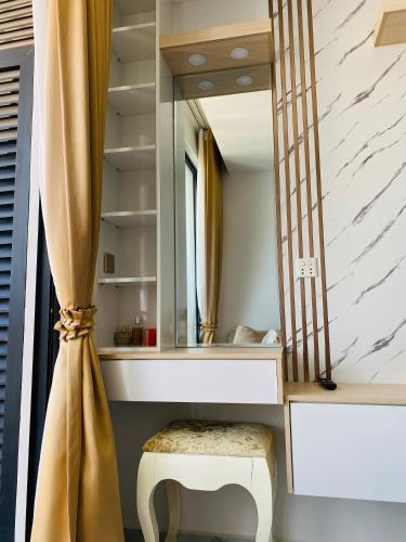a dressing room with a mirror and a stool at The Vincent Apartment in Phnom Penh