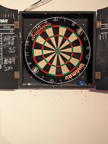 a dart board on a wall with a dartboard at Railway Inn in Culham