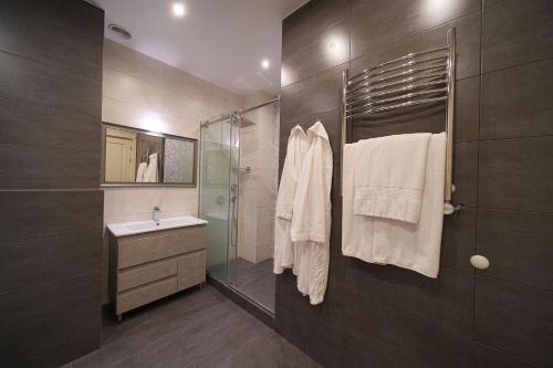 a bathroom with a shower and a sink and a mirror at Mount Ararat view 2-bedroom Luxury Apartment by Sweet Home in Yerevan