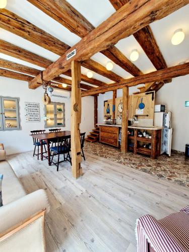 a large living room with wooden ceilings and a table at Káli Cool in Káptalantóti