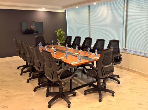 a large conference room with a long table and chairs at Hotel One The Mall, Lahore in Lahore