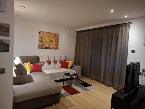 a living room with a couch and a tv at appartamento PANORAMA in Pozza di Fassa