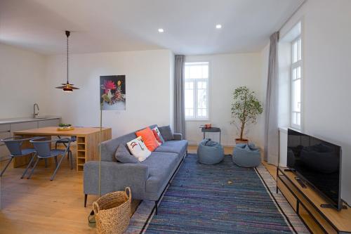 a living room with a couch and a table at Uporto House Palace in Porto