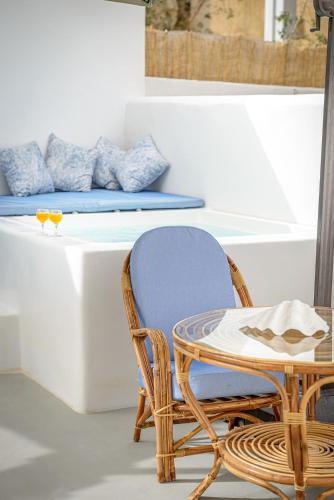 a table and two chairs and a table and a table at Caveart Villa & Prive Terrace with Prive Jacuzzi in Santorini