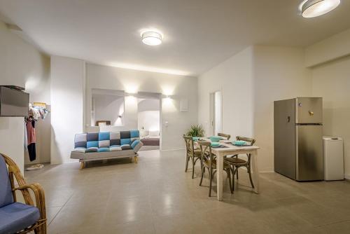 a living room with a table and a refrigerator at Caveart Villa & Prive Terrace with Prive Jacuzzi in Santorini
