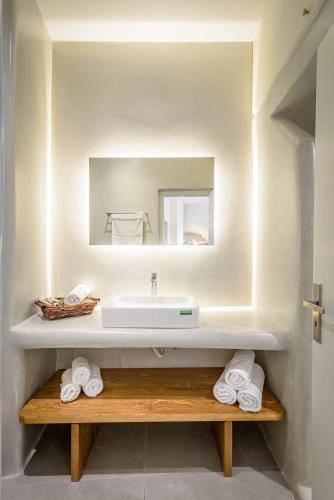a bathroom with a sink and a mirror at Caveart Villa & Prive Terrace with Prive Jacuzzi in Santorini