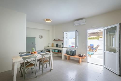 a kitchen and dining room with a table and chairs at Caveart Villa & Prive Terrace with Prive Jacuzzi in Santorini