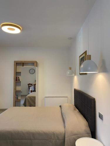 a bedroom with a bed with two lights on the wall at Agriturismo i Merli in SantʼAmbrogio di Valpolicella