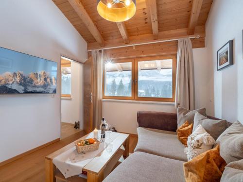 a living room with a couch and a table at Landhaus Wöss in Ellmau