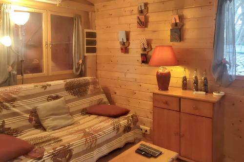a room with a couch and a lamp on a table at Chalet charmant à Poussan avec jardin privé et barbecue in Poussan