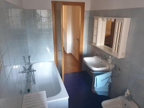 a bathroom with a white tub and a sink at Serenità in centro città in Senigallia
