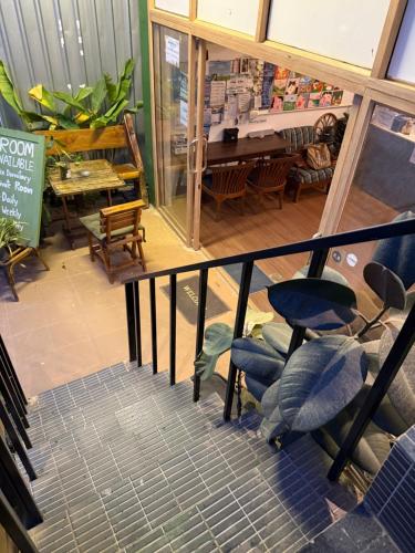 a view of a store with chairs and a piano at Happiness Hostel Private room in Phra Ae beach