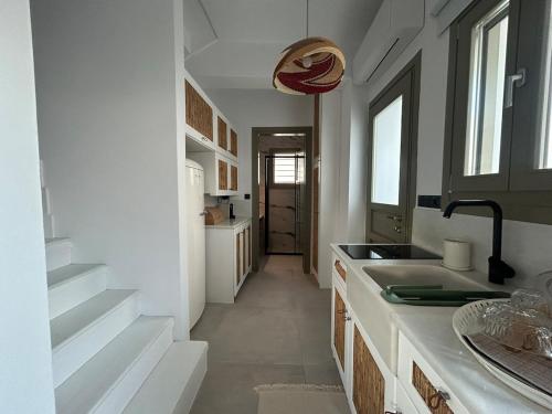 a kitchen with a sink and a counter top at Naousa Paros Suite B with private jacuzzi in Naousa