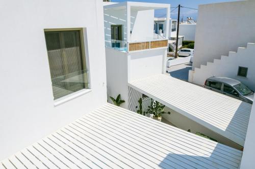 a view from the balcony of a white house at Naousa Paros Suite B with private jacuzzi in Naousa
