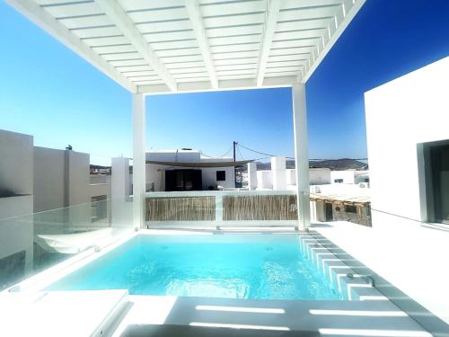 a swimming pool on the back of a house at Naousa Paros Suite B with private jacuzzi in Naousa