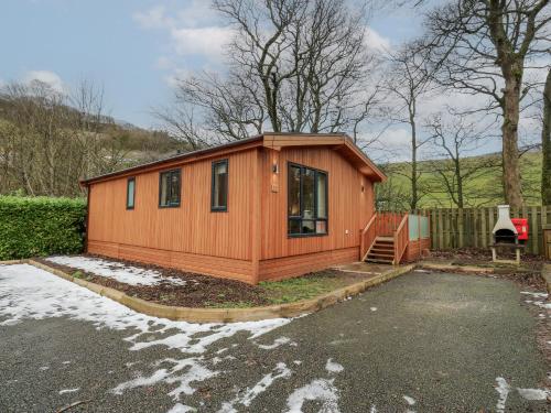 a tiny house is sitting in a parking lot at Dovestone Secluded Luxury Lodges sleeps 6 - pets welcome in Oldham
