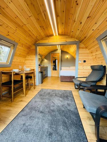 a room with a bed and a table and chairs at Plum Tree Pod in Fort William