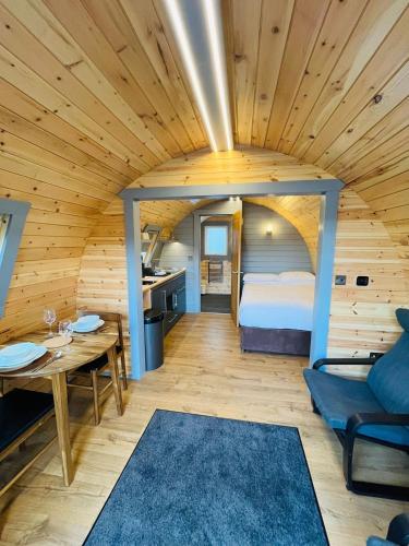 a bedroom with a bed and a table in a room at Plum Tree Pod in Fort William