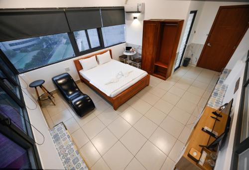 a small bedroom with a bed and a window at Yoyo Airport Saigon Hotel in Ho Chi Minh City