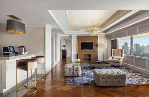 a living room with a view of the city at Dusit Thani Manila in Manila