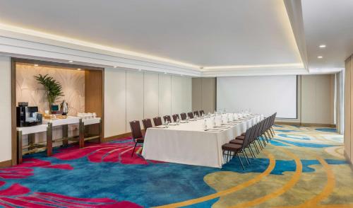 a conference room with a long table and chairs at Dusit Thani Manila in Manila
