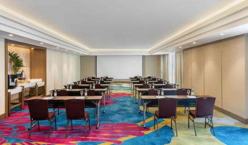 a large room with tables and chairs in it at Dusit Thani Manila in Manila