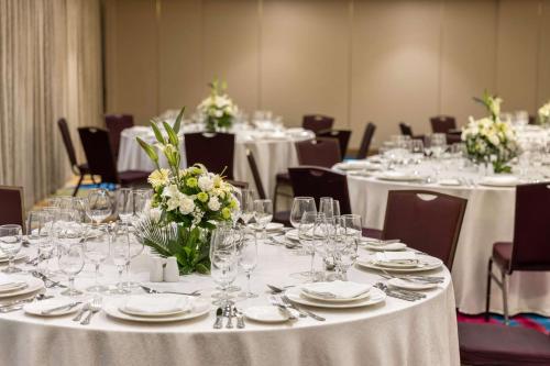 a room filled with tables with white tablecloths at Dusit Thani Manila in Manila