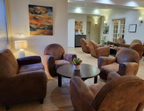 a waiting room with chairs and a table at Best Western Blanche de Castille Dourdan in Dourdan