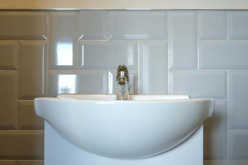 a bathroom sink with a faucet on top of it at The Willow - Studio 23 in Bristol