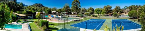 a park with a pool, lawn chairs, and a tennis court at BIG4 NRMA Halls Gap Holiday Park in Halls Gap