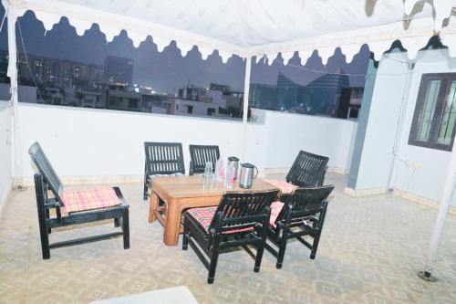 a table and four chairs in a white tent at Hotel Comfort Inn in Jaipur