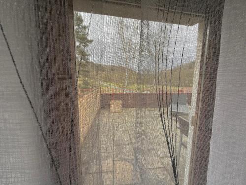 an open window with a view of a yard at Haus zum guten Hirten in Steinsfeld