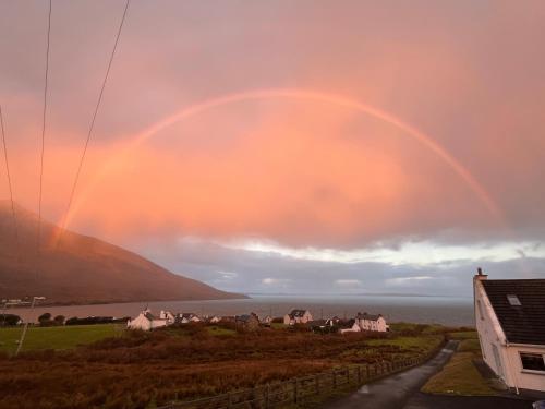 a rainbow in the sky over a city at Sea views in Dugort in Achill Island