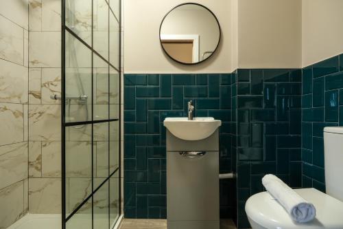 a bathroom with a toilet and a sink and a mirror at The Willow - Studio 30 in Bristol